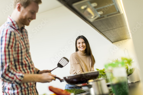 Young couple preparing meal