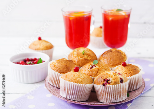 Tasty muffin (cupcake) with cranberries and cranberry-orange drink.