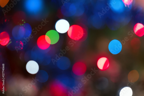 Abstract festive background with bokeh effect. Christmas tree and garlands of bright