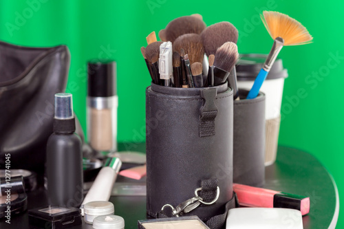 Beauty products for professional make-up a green background