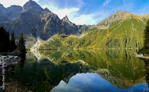 Fototapeta Naklejka Na Ścianę i Meble -  Crystal clear lake in high mountains - wide panorama of morskie Oko - lake in Tatra Mountains