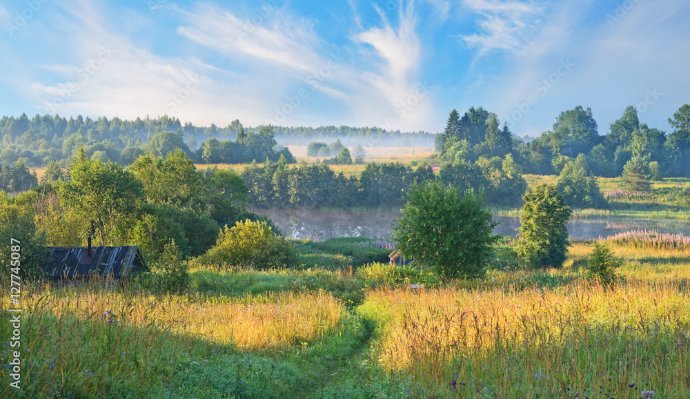 The river and outskirts of village on warm summer morning. The river and outskirts of village on warm summer morning.