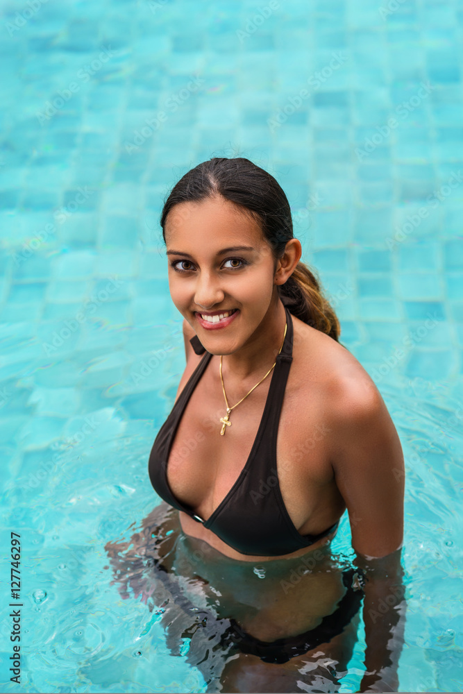 Attractive Indian woman in a swimming pool