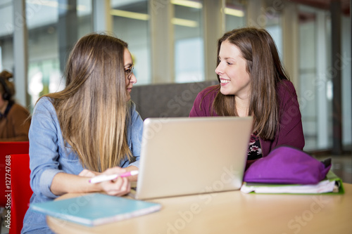 pretty female college student studying in the university library