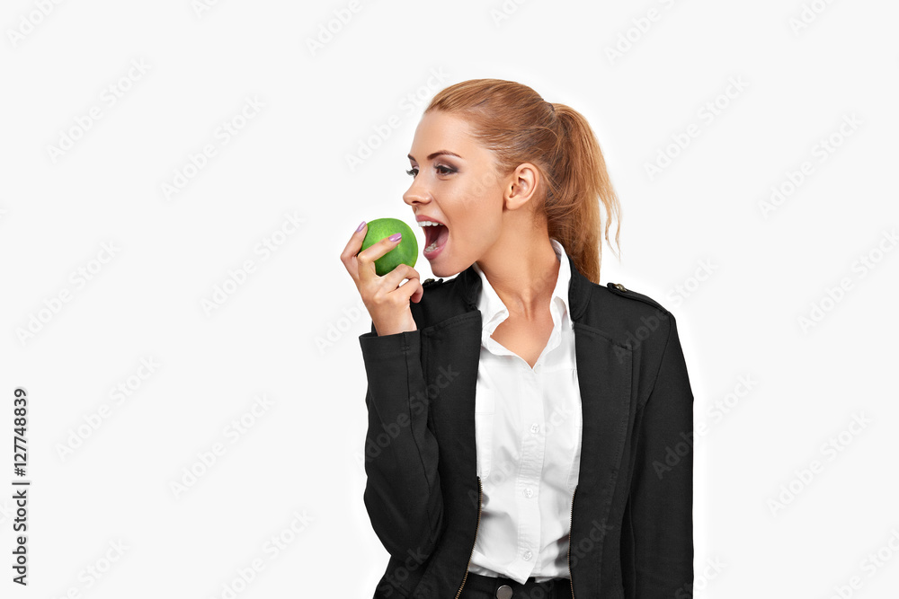Portrait of a young business woman. She is eating a green apple. Isolated on white background Portrait of a young business woman. She is eating a green apple. Isolated on white background
