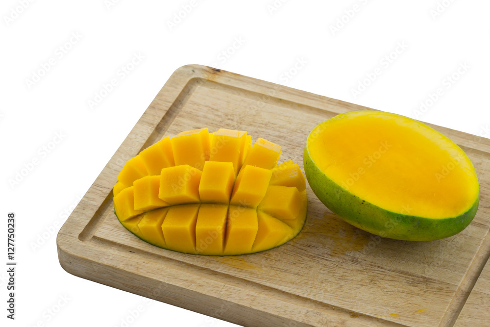 Fresh ripe mango cut into pieces on cutting board / Mango cut in a grid pattern and whole mango on white background / Fresh Mango on cutting wood board / Sweet Mango ripe on white background