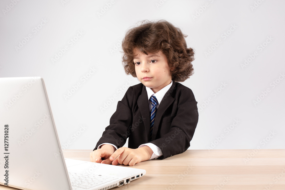 Little curly businessman typing on the keyboard. Gray background. Little curly businessman typing on the keyboard. Gray background.
