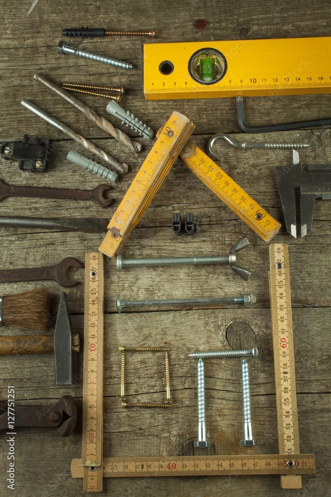 Plans to build a house. Rustic wooden background. Tools for builders. Architect designing a house for a young family. House from nails and screws. Needed for building. Ideas about building a house.
Plans to build a house. Rustic wooden background. Tools for builders. Architect designing a house for a young family. House from nails and screws. Needed for building. Ideas about building a house.