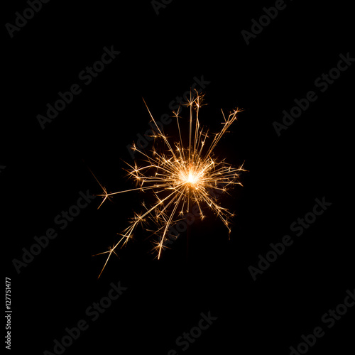 Burning sparkler isolated on black background