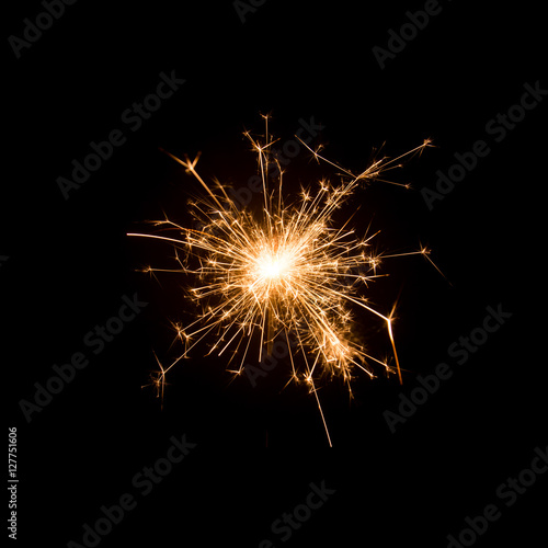 Burning sparkler isolated on black background