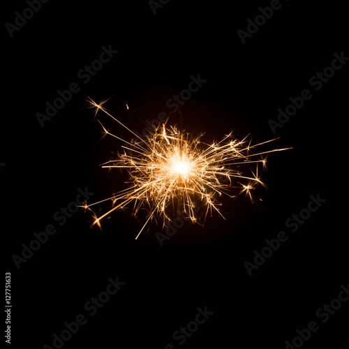 Burning sparkler isolated on black background