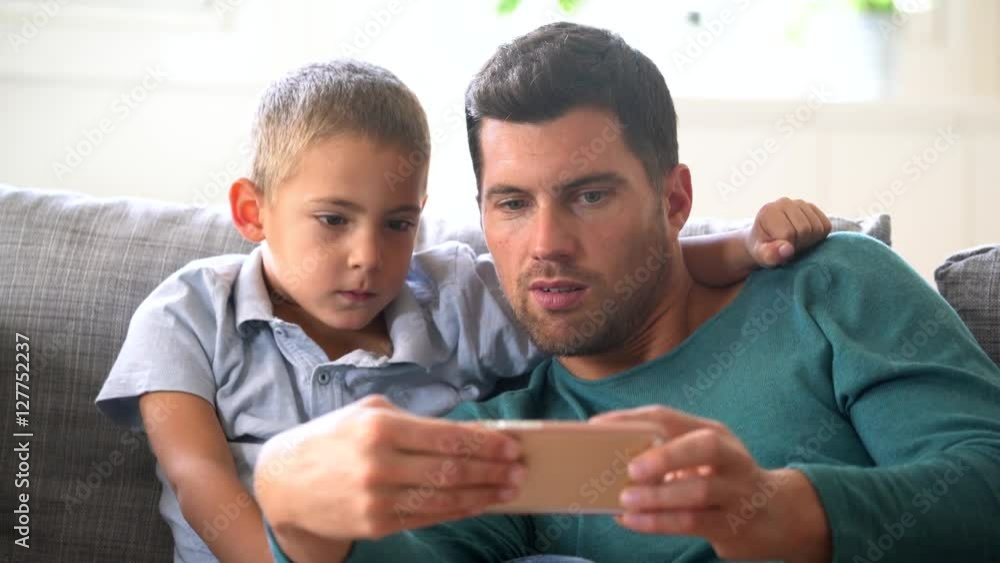 Daddy with son playing with smartphone Daddy with son playing with smartphone