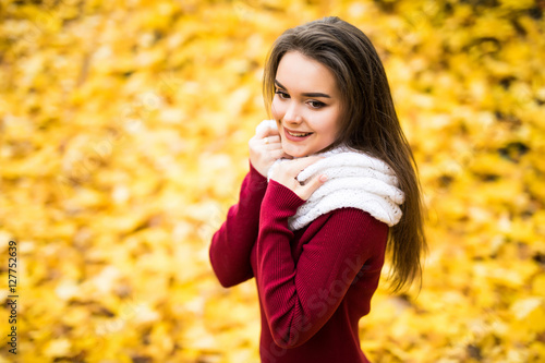 Beauty girl outdoors in autumn forest with yellow leaves from above