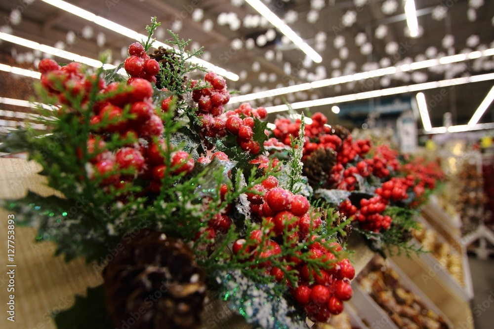 Christmas souvenir artificial snow on the pine tree branches and red berry 