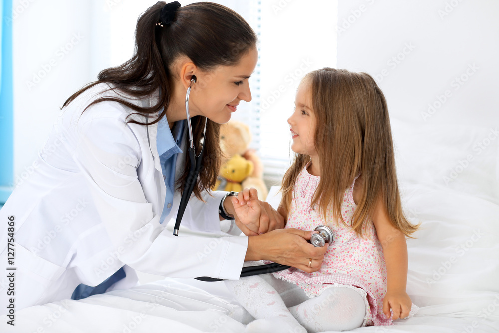 Doctor examining a little girl by stethoscope Doctor examining a little girl by stethoscope