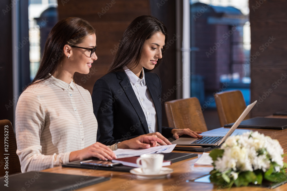 Concentrated female colleagues working together Concentrated female colleagues working together