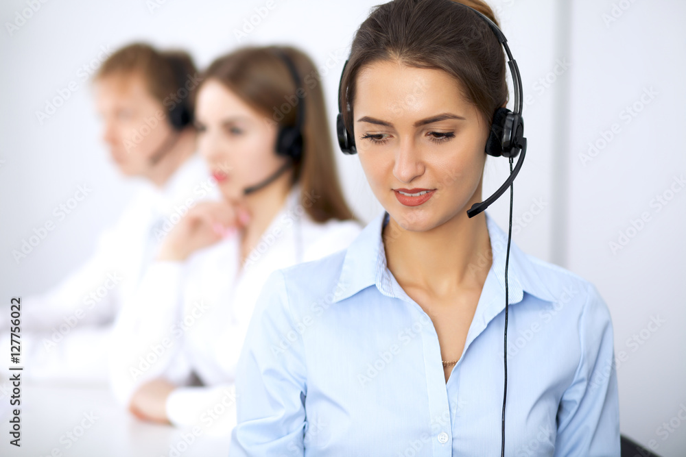 Call center. Focus on beautiful woman in headset Call center. Focus on beautiful woman in headset
