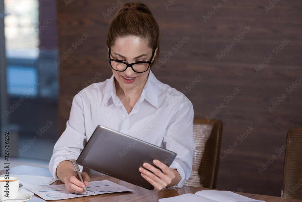 Beautiful woman working hard on project in an office Beautiful woman working hard on project in an office