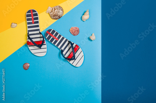 Top view of sandy beach with summer accessories and copy space around products. Blank mock up for advertising or packaging. Colourful frame with graphical backdrop photo