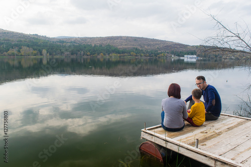 Family enjoying autumn by the lake