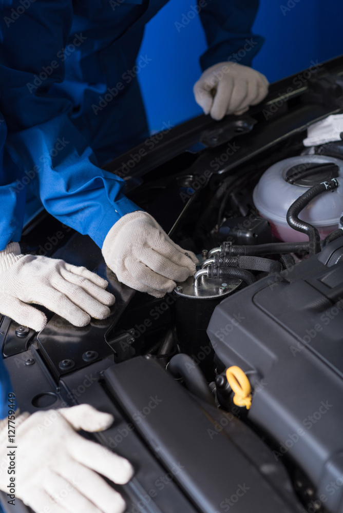 Professional mechanics working on car break out Professional mechanics working on car break out