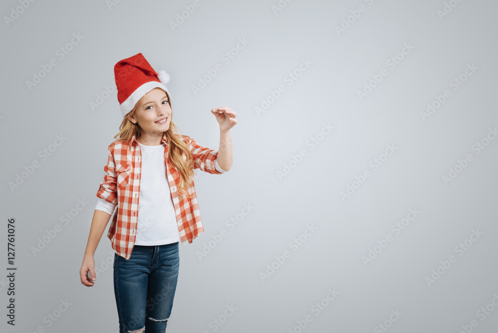Cheeful smiling little girl holding Christmas bell Cheeful smiling little girl holding Christmas bell