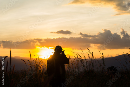 standing on a mountain, enjoying the sunset