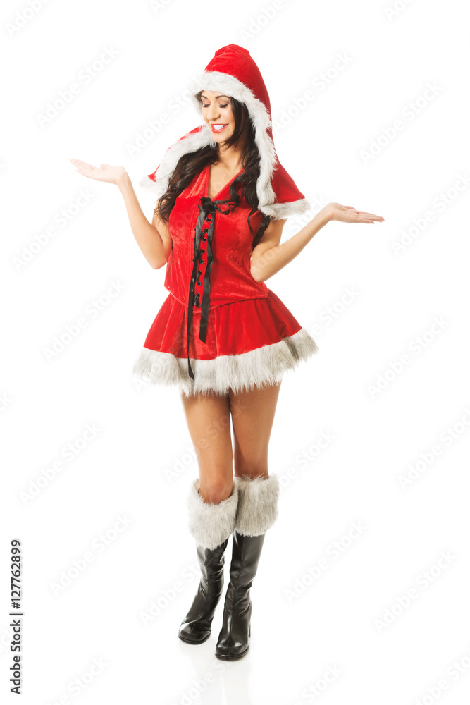 Full length woman with open hands gesture wearing santa clothes Full length woman with open hands gesture wearing santa clothes