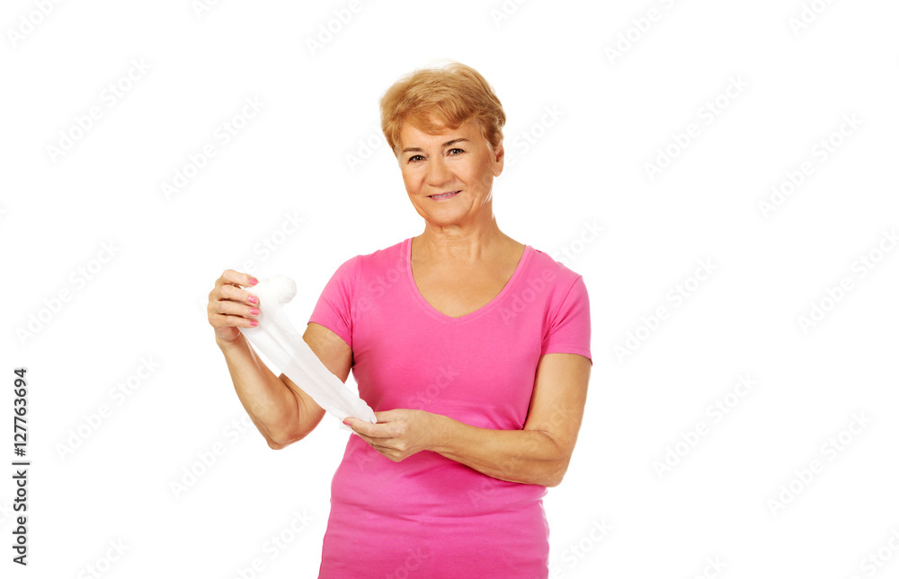 Smile senior woman holding bandage Smile senior woman holding bandage