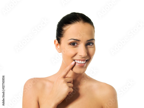 Dental health concept - beautiful woman pointing to her teeth