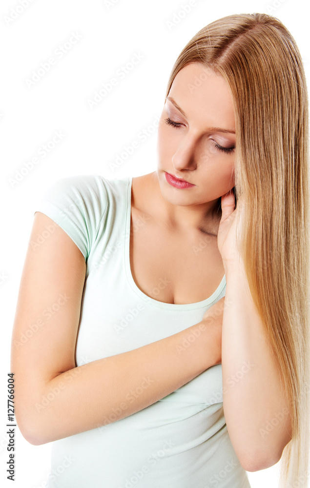 A young sad woman, isolated on white background. A young sad woman, isolated on white background.