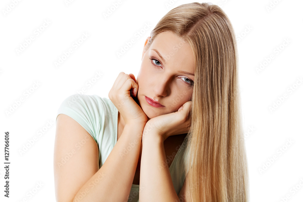 A young sad woman, isolated on white background. A young sad woman, isolated on white background.