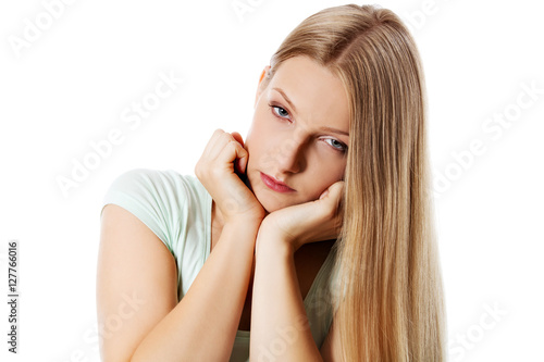 A young sad woman, isolated on white background.