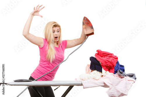 Woman having enough of ironing clothes