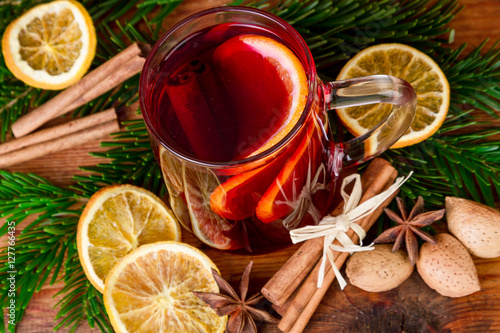 Christmas mulled wine with spices on wooden background. Top view.