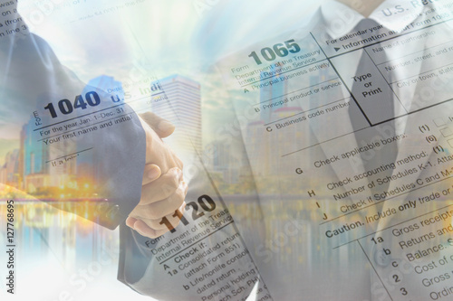 Double exposure of business handshake and tax form for taxation concept