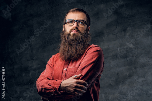 A bearded male in eyeglasses dressed in a red shirt. © Fxquadro