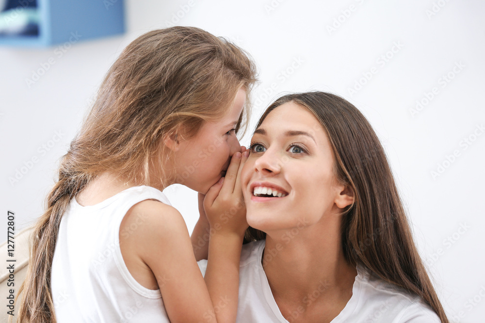Cute girl with mother at home