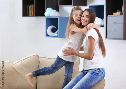 Cute girl with mother at home