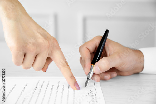 Man signing marriage contra...