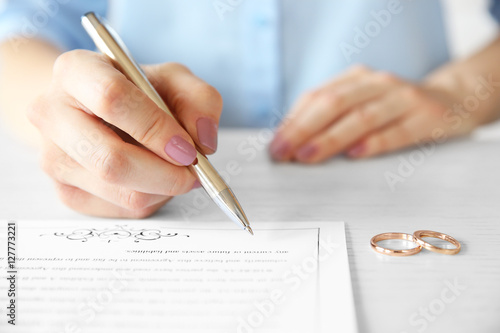 Woman signing marriage cont...
