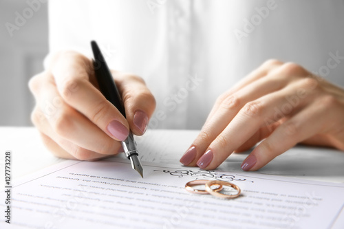 Woman signing marriage cont...