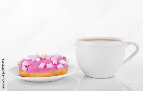 Delicious doughnut and cup of coffee isolated on white