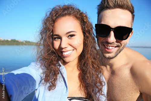 Happy couple taking selfie ...
