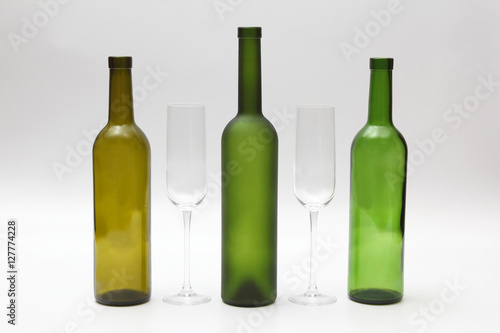 empty bottles and wine glasses on a white background