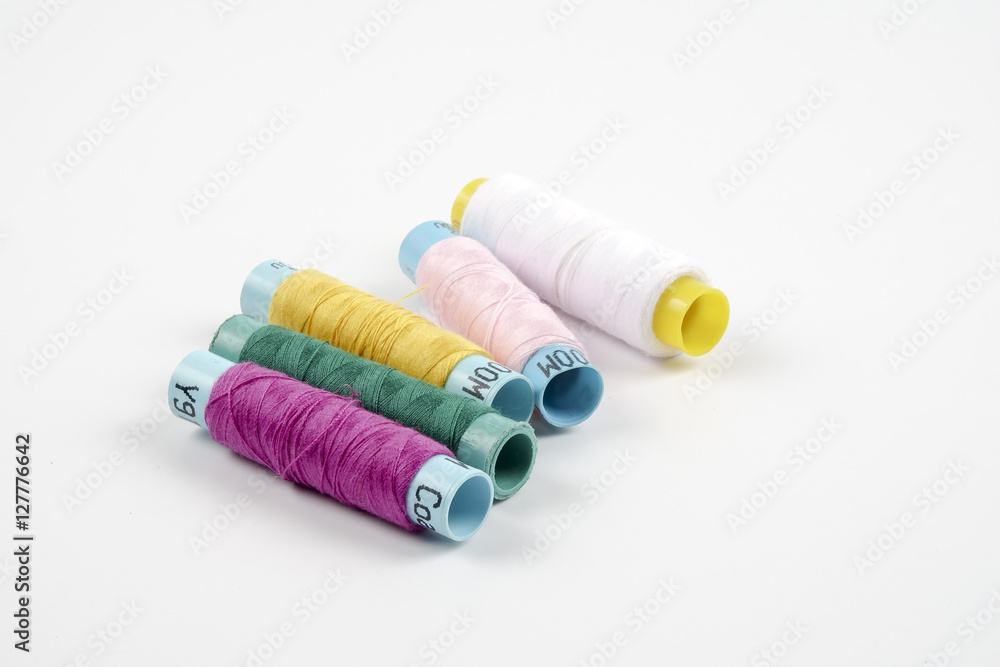 Sewing colored threads isolated on white background Sewing colored threads isolated on white background