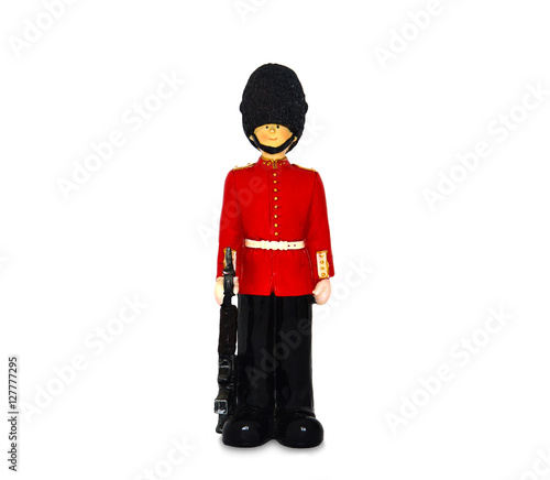 Queen's guard statue in traditional uniform with weapon, British soldier, isolated on white background