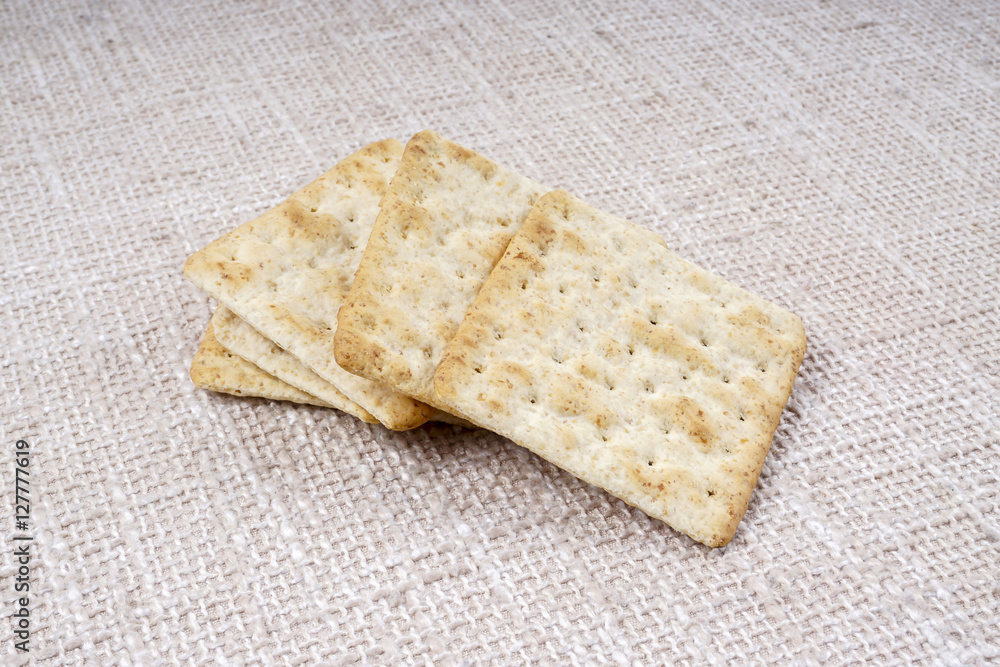 the cream cracker biscuit on the wooden background.