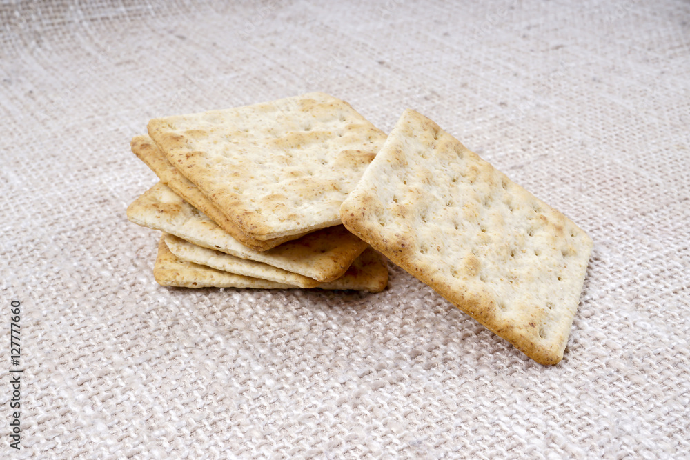 the cream cracker biscuit on the wooden background. the cream cracker biscuit on the wooden background.
