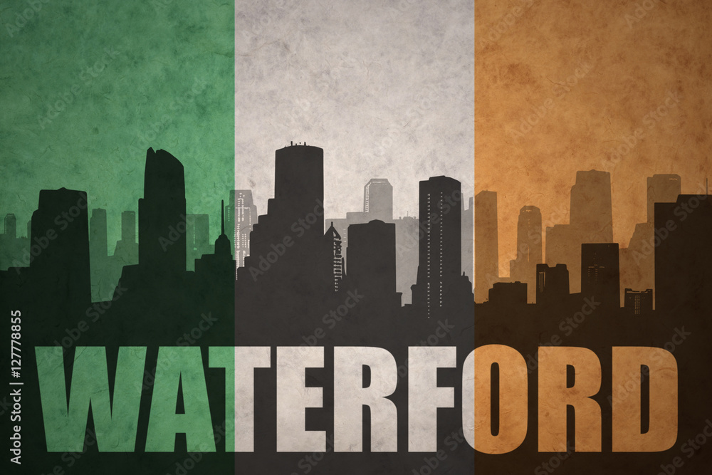 abstract silhouette of the city with text Waterford at the vintage irish flag